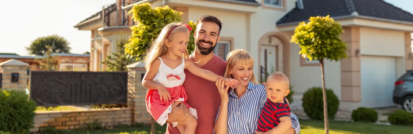 Family standing in front of home